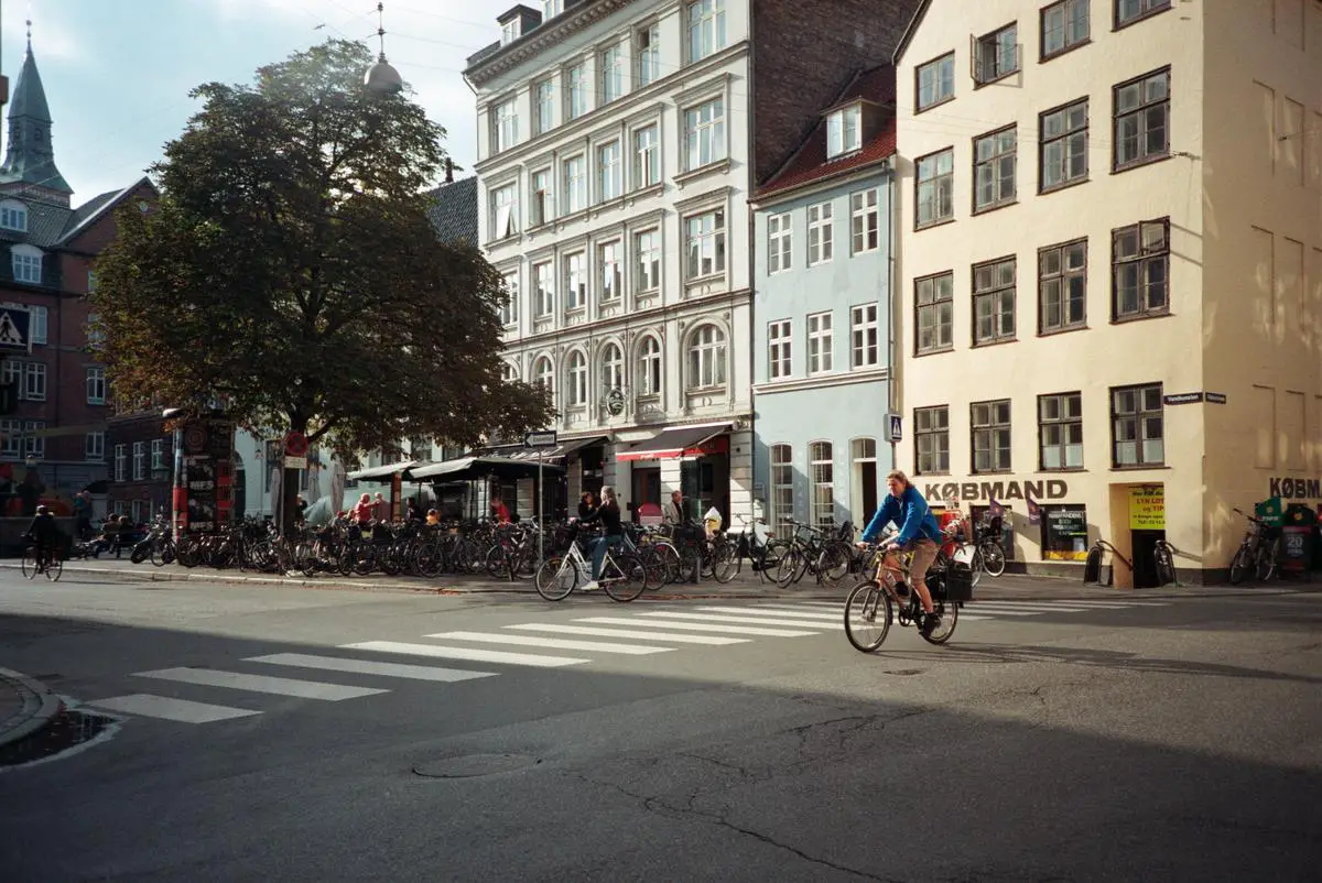 A cyclist on a city street surrounded by cars