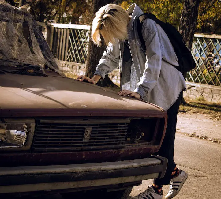 Image of a person standing beside a broken-down car, illustrating the concept of car troubles.