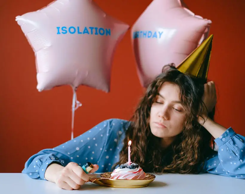 A person looking sad with a party hat in the background, representing the feeling of regret for not being able to attend a social event.