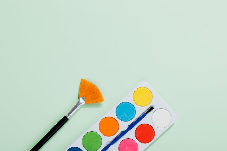 Image depicting a paint palette with various financial symbols on each color, representing the concept of financial management in different shades
