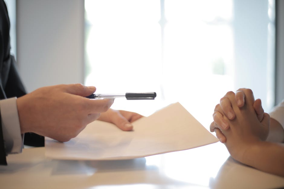 Image depicting a businessman holding a contract, symbolizing legal and ethical considerations in double-booking practices