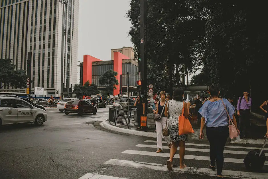 An image of pedestrians crossing the street while cars wait behind them impatiently