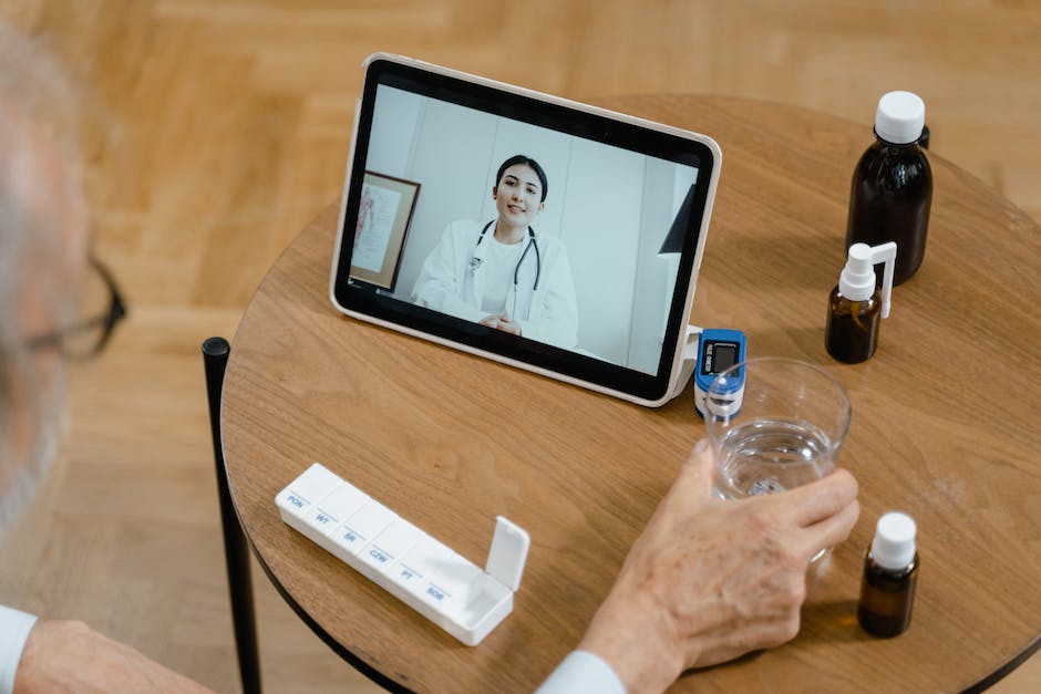 A person using a laptop to attend a virtual appointment with a doctor during quarantine